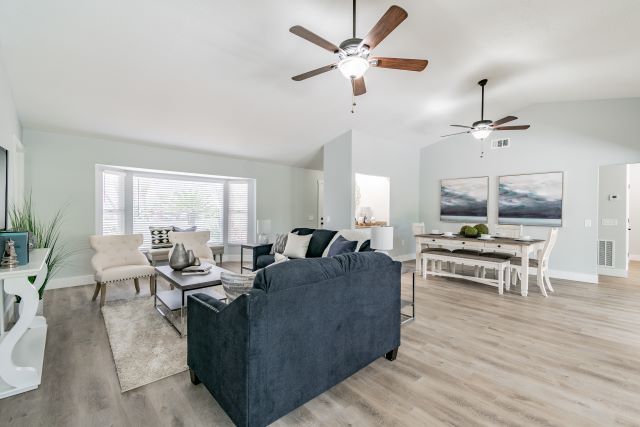 a living room with a fan and couches