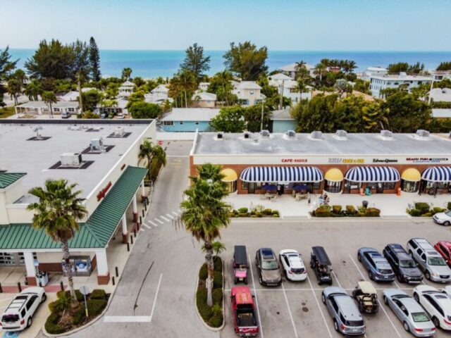 a parking lot with cars and buildings and trees